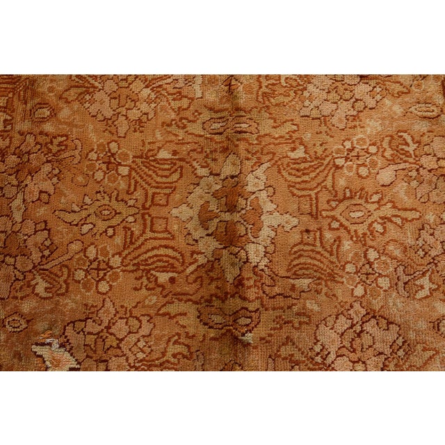 This antique Oushak rug from early 20th-century Turkey is an exquisite example of Anatolian craftsmanship, prized for both...