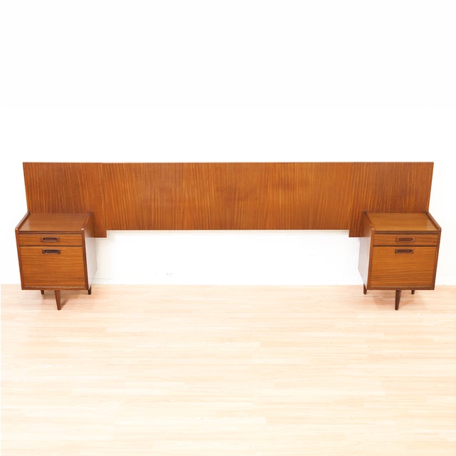 A striking mid-century headboard system in richly grained teak by White & Newton, combining clean architectural lines with...