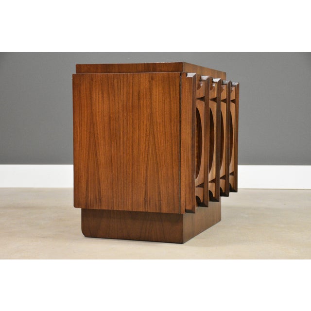 A mid century modern brutalist style walnut two door nightstand. Excellent original condition. Made in Canada. Circa...
