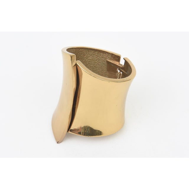 This vintage 1970's gold plated wide cuff bracelet is very sculptural. Not marked but wonderful. HInged. Makes a statement...