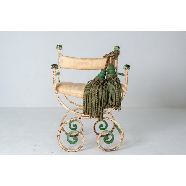 A unique antique, circa 1920, wrought iron curule armchair from a significant Cincinnati estate. Also referred to as a...