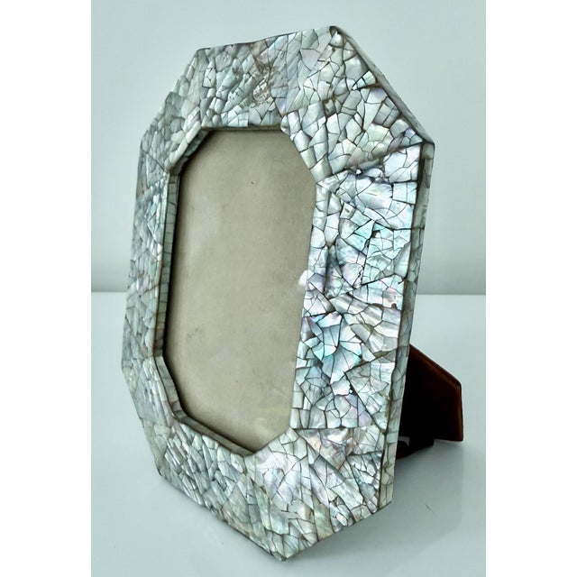 A beautiful abalone seashell picture frame attributed to Maitland-Smith, circa late-20th century. Picture frame is...