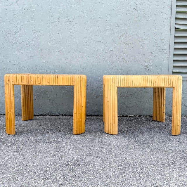 A striking pair of vintage boho chic side tables crafted in split bamboo with sculptural waterfall-style construction....