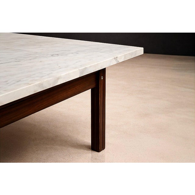 A sculptural Brazilian Modern coffee table by Ziglio Decorações, executed in solid rosewood with a refined marble top,...