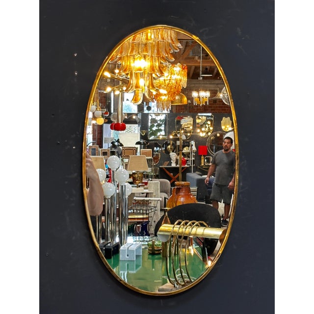 The Vintage Italian 1980 Oval Brass Wall Mirror is a classic and elegant piece with a timeless oval shape and a beautiful...