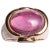 A spectacular large pink tourmaline cabochon dome ring set in 18K gold. It is flanked by two marquise cut tanzanite stones...