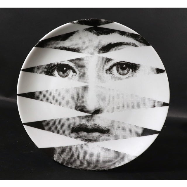 "Fractured Beauty": Fornasetti "Themes & Variations" Plate #46 (Sliced Face) 1990s A dynamic and optical porcelain wall...