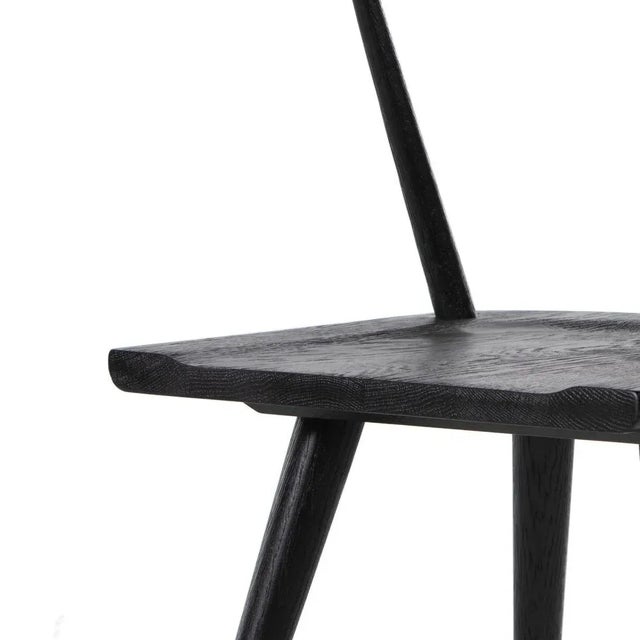 This new take on the mid-century Windsor chair has a bowed, sculptural silhouette. A soft black finish adds movement to...