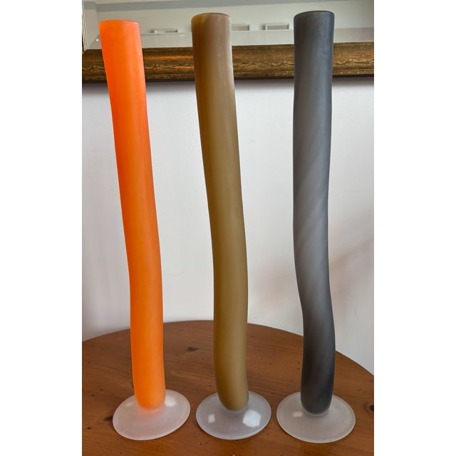 These vases are approximately 24 inches tall with a matte finish and a clear flat base. They are minimalist design and...