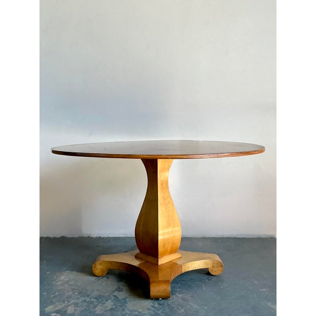 This striking center table pays homage to the elegant curves and solid forms of the early 19th-century Biedermeier style,...