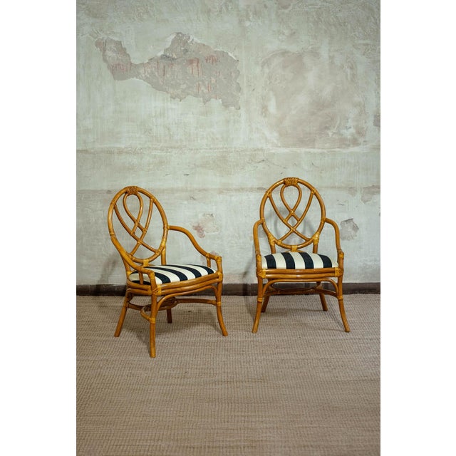 Crafted in bamboo and featuring a curved backrest with a woven pattern. It showcases visible rattan bindings and a padded...