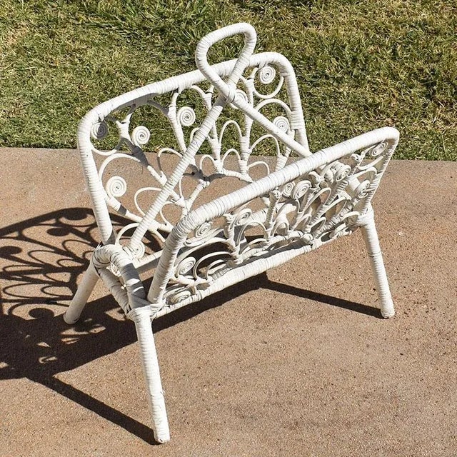 A whimsical white-wrapped rattan magazine rack. This piece reminds us of the 1970s and the popular peacock chairs that...