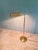 Articulated brass floor/reading lamp, Hollywood Regency style, 1970s-80s. The lampshade rotates 360° around the central...