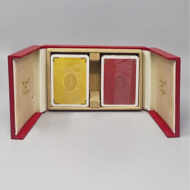 1970s Original astonishing playing cards box by Cartier with is red leather original box 2-doors case . The box is lined...