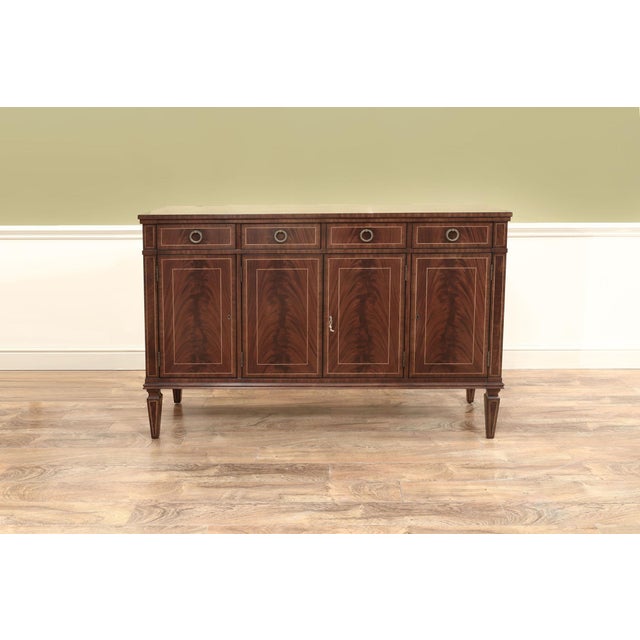 High-end flame mahogany Regency-style sideboard in a rectangular form. Hepplewhite-style small sideboard with generous...