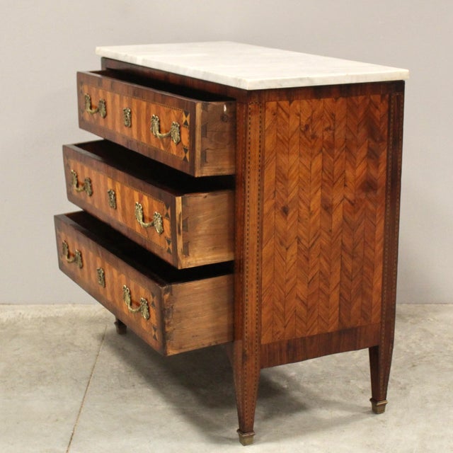 Louis XVI chest of drawers with inlaid and trim, a marble top, and original gilded bronzes - note the small size. Late...