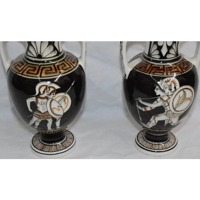 Greek Keys accent these Classic vases featuring soldiers in battle. Each has curved handles made of the white porcelain...