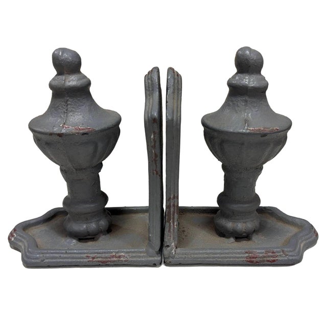 Cast iron grey bookends showcase a traditional aesthetic with intentional antiquing, and paint chips that exude vintage...