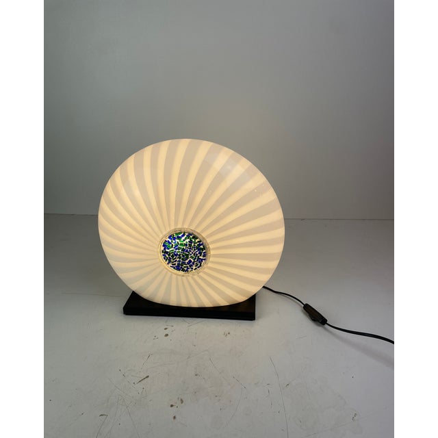 Striking post-modern table lamp crafted in hand-blown murano glass, featuring a sculptural white and clear spiral diffuser...