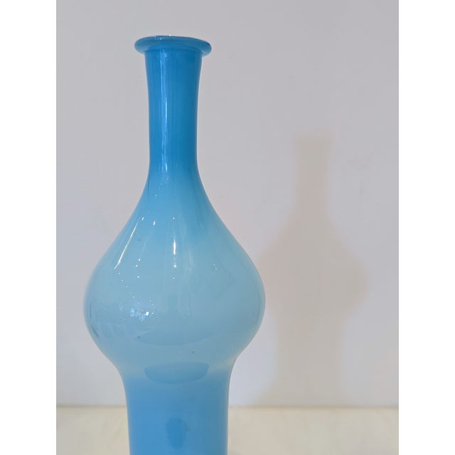 A cased glass vase from Empoli, Tuscany, 1960s–70s. Features biomorphic form with pinched waist and ombré sky-blue...