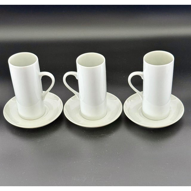 Elevate your espresso service with this striking set of porcelain demitasse cups and saucers, designed by legendary...