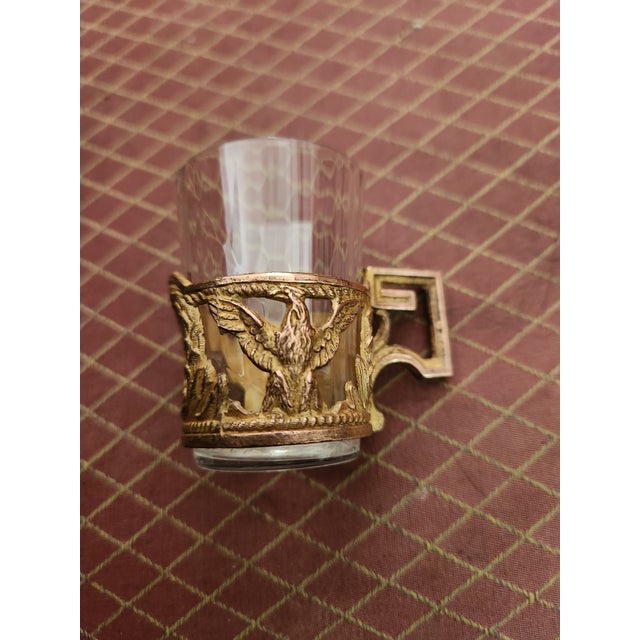 Delicate liqueur set Gilt bronze with eagle motif Empire style Very good condition Decanter height: 22 cm Glass height: 5 cm