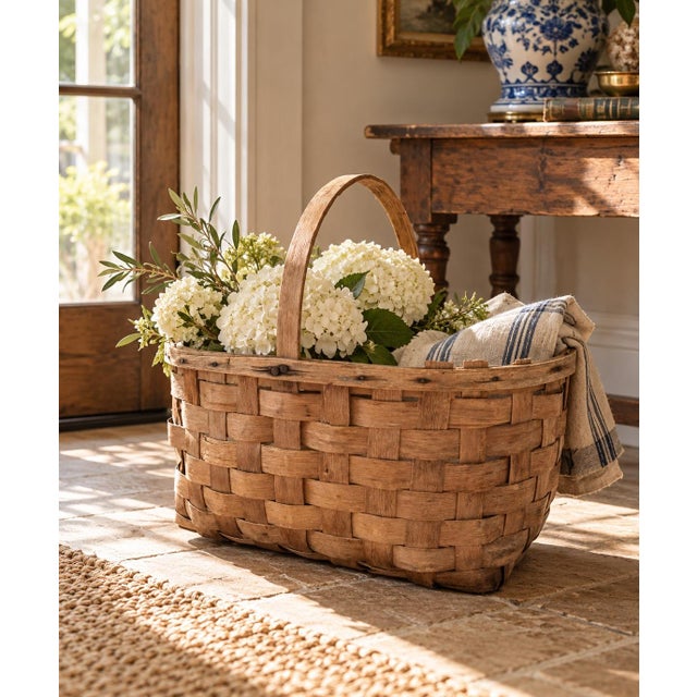 A beautifully handwoven early 20th century split oak basket with generous scale and a wonderfully time-softened surface....