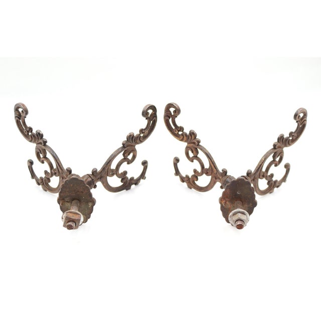 Victorian style hall tree hooks with double arms made of cast iron with a bronze finish. There are mounting screws with...