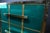 Italian aqua-blue Murano glass chest of drawers with polished brass details. Four drawers are arranged in a two-by-two...
