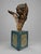 A dramatic antique Continental carved cherub fragment, modeled as a winged putto head or angelic bust mounted on a later...
