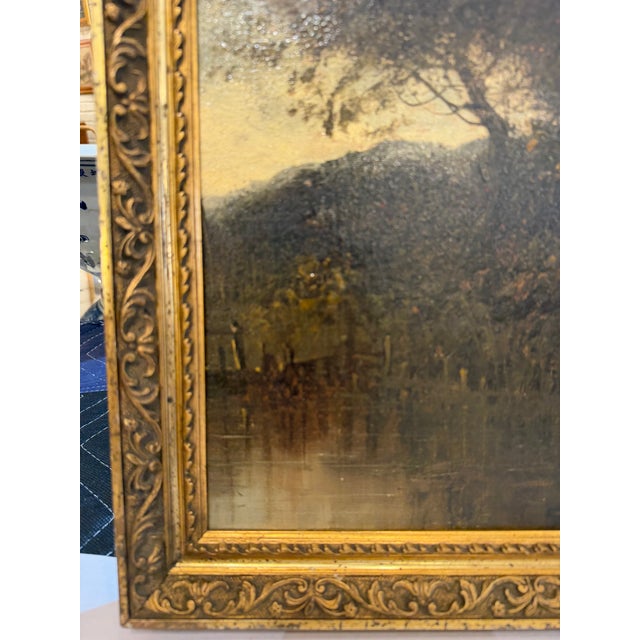 A charming 19th Century Barbizon School oil painting depicting a serene countryside landscape at dusk. A lake reflects on...