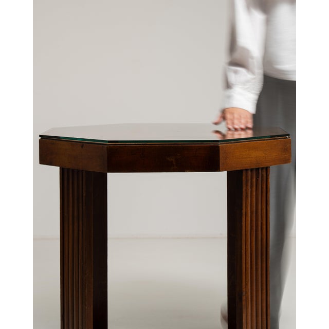 This 1920s Art Deco side table from France is finished in amber, worked in glass. It is distinguished by its glass top, a...