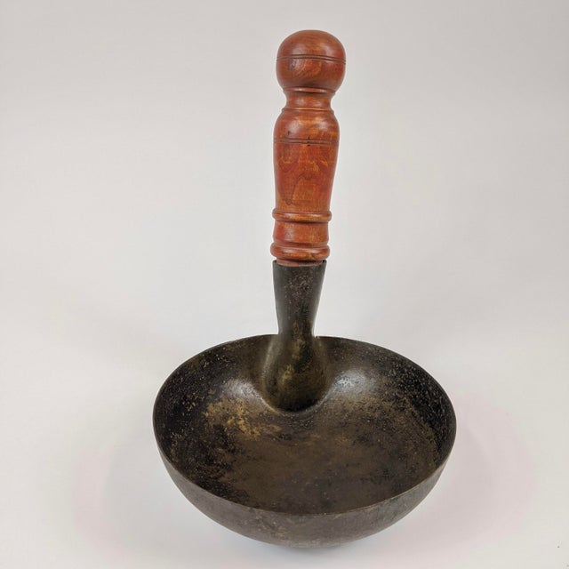 This large Chinese 20th century ladle will surely be a great decorative item.. It has a wooden handle and a brass bowl.