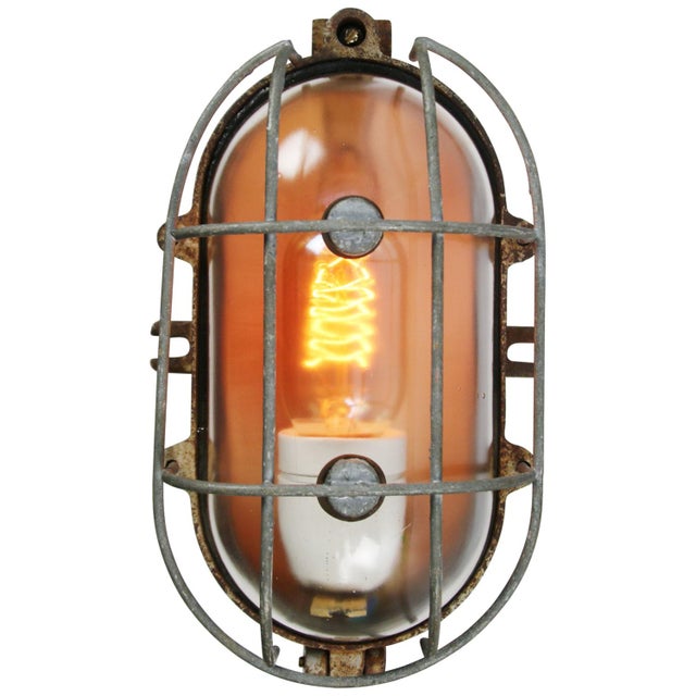 industrial wall or ceiling lamp made by Industria Rotterdam cast iron, clear glass E27/E26 This piece has an attribution...