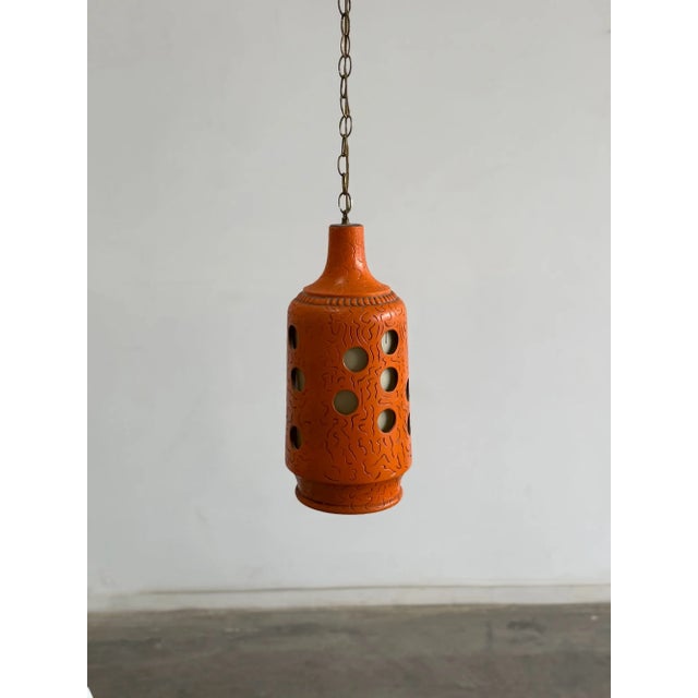 W9 H20 cord 110 A ceramic swag lamp featuring a bold, cylindrical silhouette and hand-etched "sgraffito" textures. The...