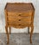 A French oak bedside tables with three drawers from early 20th century. This French 'table de chevet' features a...