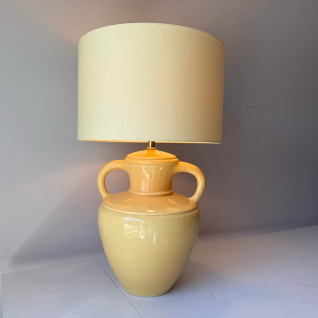 Vintage signed Vanguard Pottery yellow glazed double handle jug table lamp paired with a large citron barrel lampshade.
