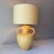 Vintage signed Vanguard Pottery yellow glazed double handle jug table lamp paired with a large citron barrel lampshade.