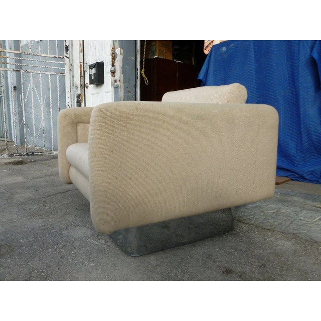 This is a luxurious Milo Baughman style club chair with a thick chrome base. The piece is from the 1970s.