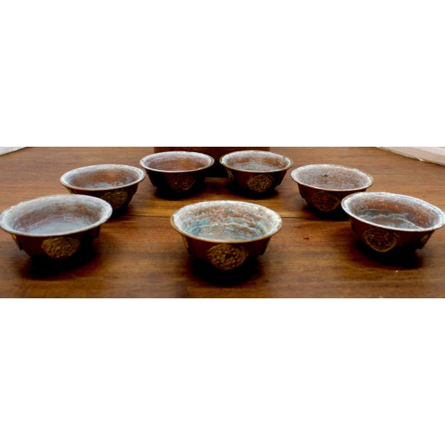 This authentic set of seven Tibetan Buddhist Yonchap — water offering bowls —each measuring 3.25 inches in diameter by...