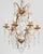 An early 20th century French Louis XV style six-light chandelier with an assortment of crystal prisms and pendalogues,...
