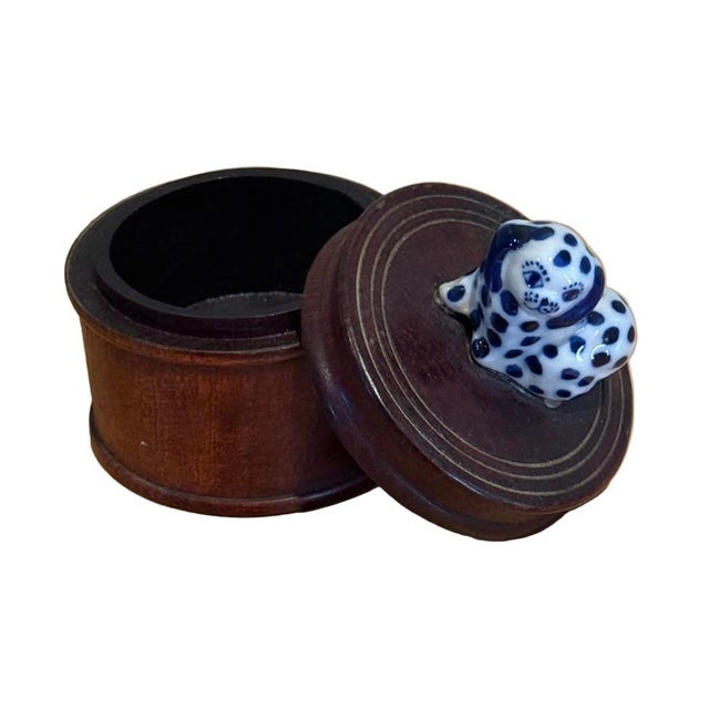 Charming turned wood lidded trinket box topped with a hand-painted blue-and-white ceramic dog finial in a classic Delft-...