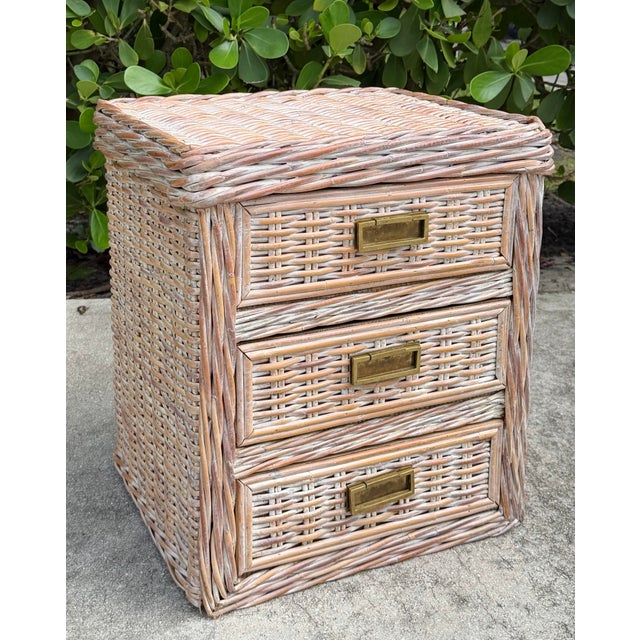 Beautiful vintage low chest crafted in substantial braided rattan, featuring three drawers with brass pulls. The rattan...
