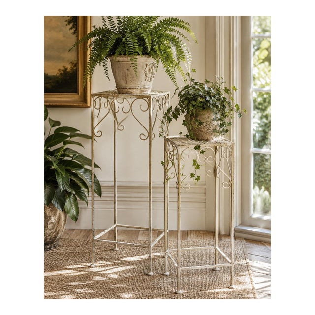Pair of Vintage Indoor/Outdoor Hollywood Regency Graduated Metal Plant Stands, Distressed Ivory Scrollwork For Sale