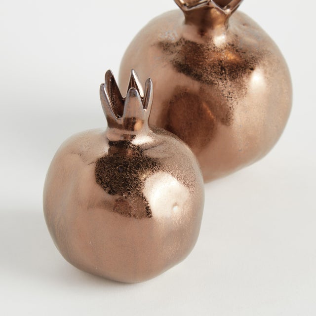 With a rich bronze glaze, uneven texture and organic form, these little pomegranate bud vases are simple and raw. Freshly...