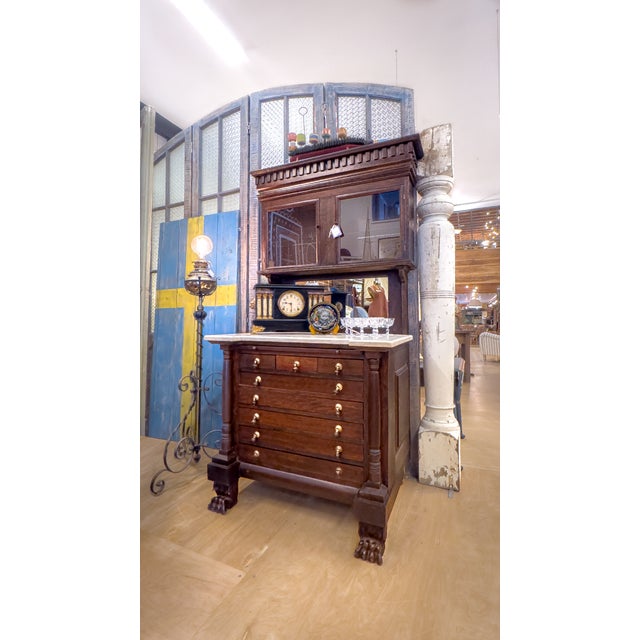 Discovered on the property of a pig farmer in rural Oregon, this Empire era dental cabinet is in stunning condition. With...