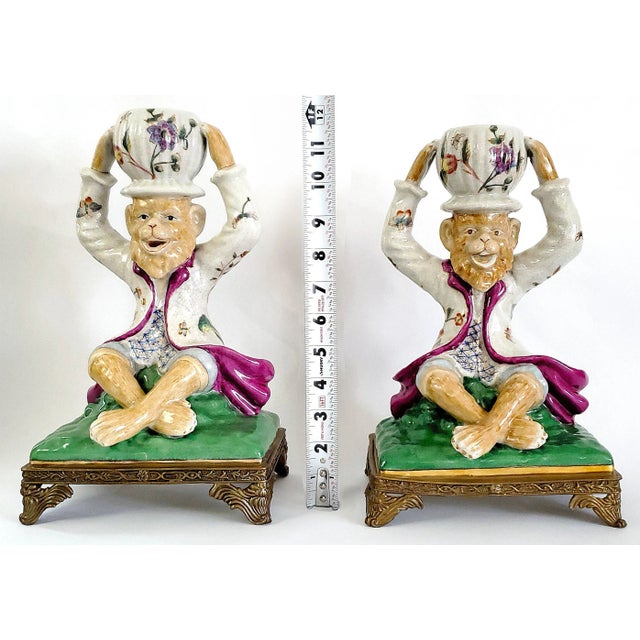 Offering a whimsical LARGE pair of hand painted Chinese intentionally crackled porcelain monkeys, circa Late 20th Century,...