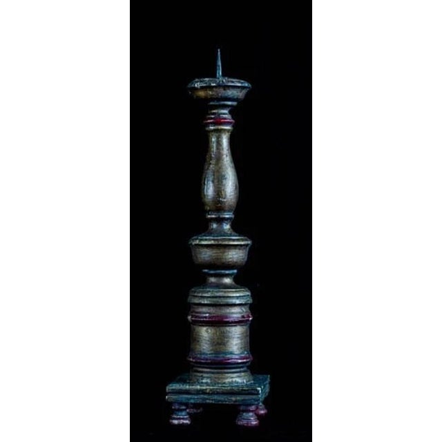 A striking antique wooden pricket candleholder of unusually tall, architectural form, finely turned and carved with a...