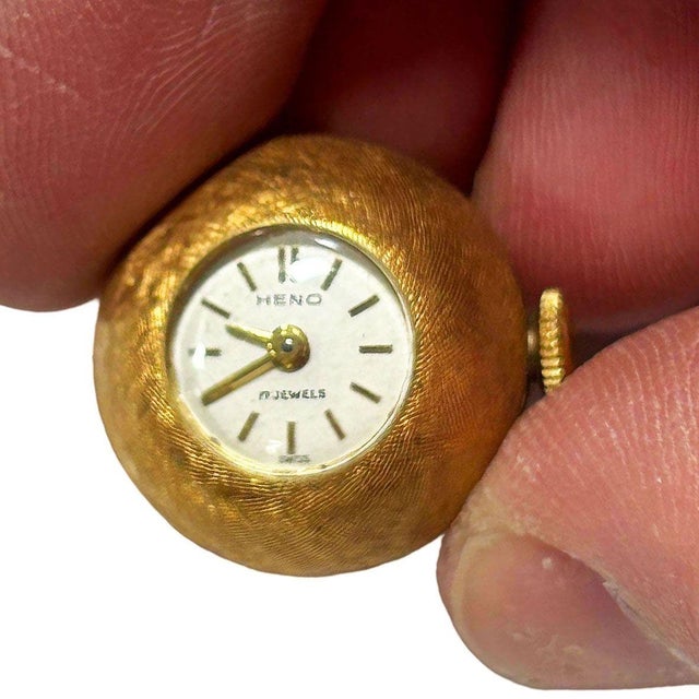 A charming and distinctive example of mid-century Swiss horological design, this "orb" or ball-shaped pendant watch by...