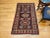 This exceptional mid-20th century vintage Persian Kurdish area rug features a striking geometric medallion design...
